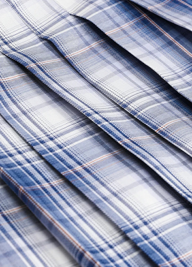Close-up of the fabric on a women's white blue plaid elastic waist pleated skirt