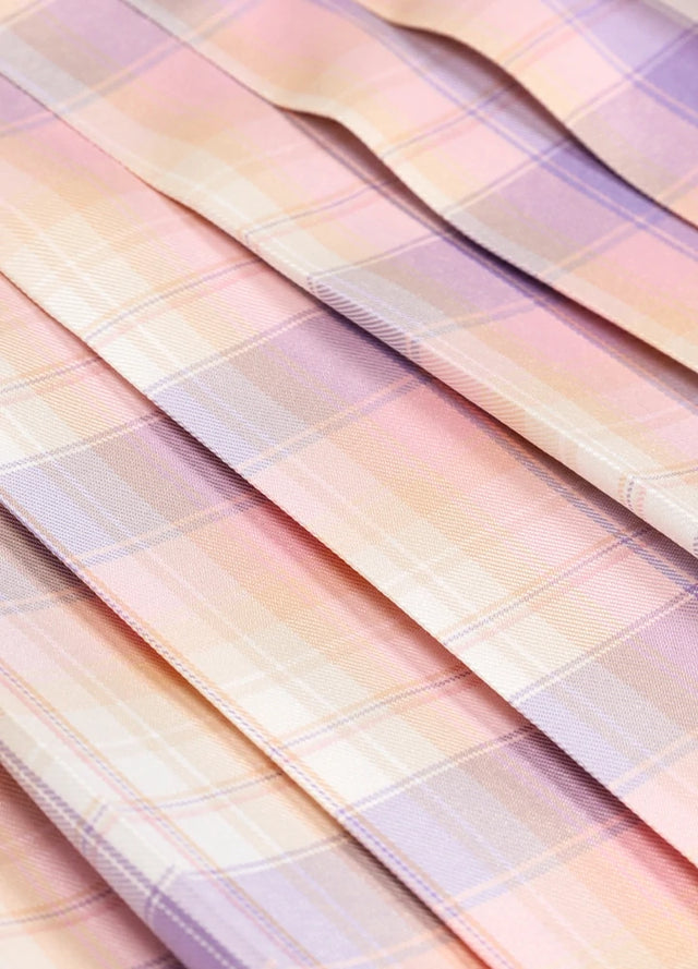 Close-up of the fabric on a women's pink blue plaid elastic waist pleated skirt