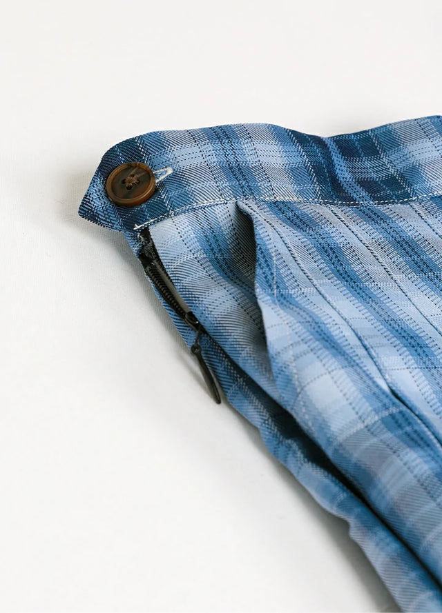 Close-up of women's blue plaid high-waisted mini skirt side pocket