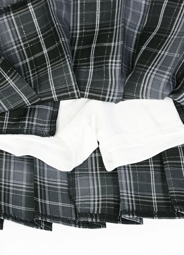 Zoomed-in view of the built-in elastic shorts on a women's gray plaid mini skirt