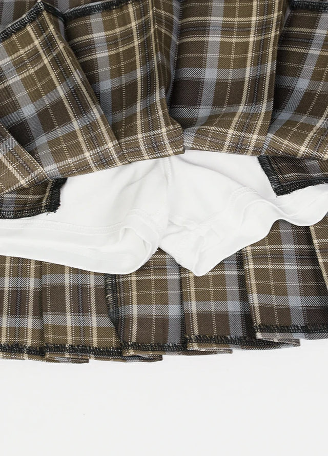 Zoomed-in view of the built-in elastic shorts on a women's brown plaid mini skirt