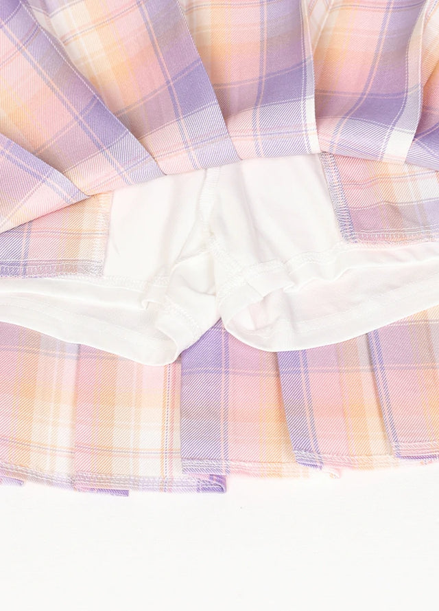 Zoomed-in view of the built-in elastic shorts on a women's pink blue plaid mini skirt