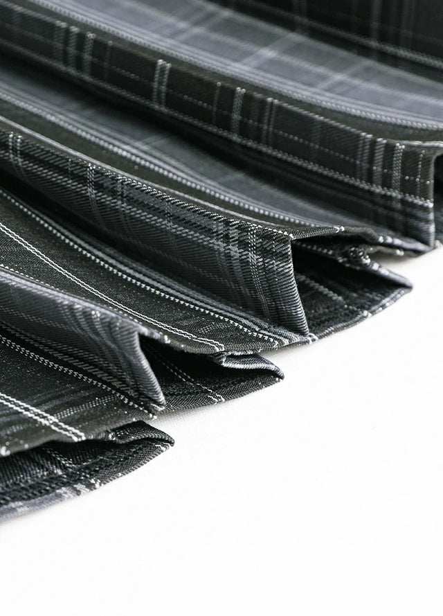 Detailed view of womens built-in elastic shorts gray plaid mini pleated skirt hem