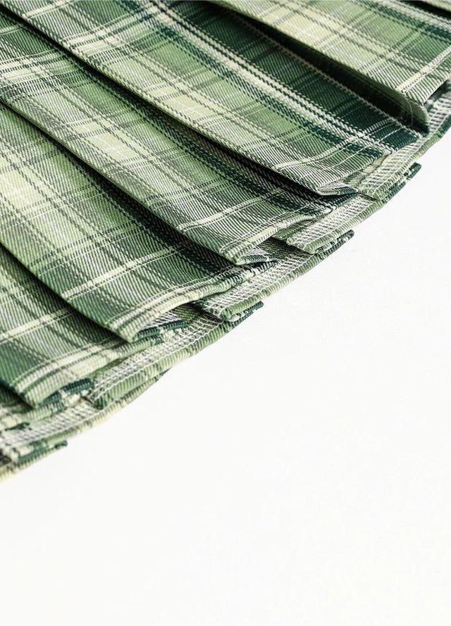 Detailed view of womens built-in elastic shorts green plaid mini pleated skirt hem