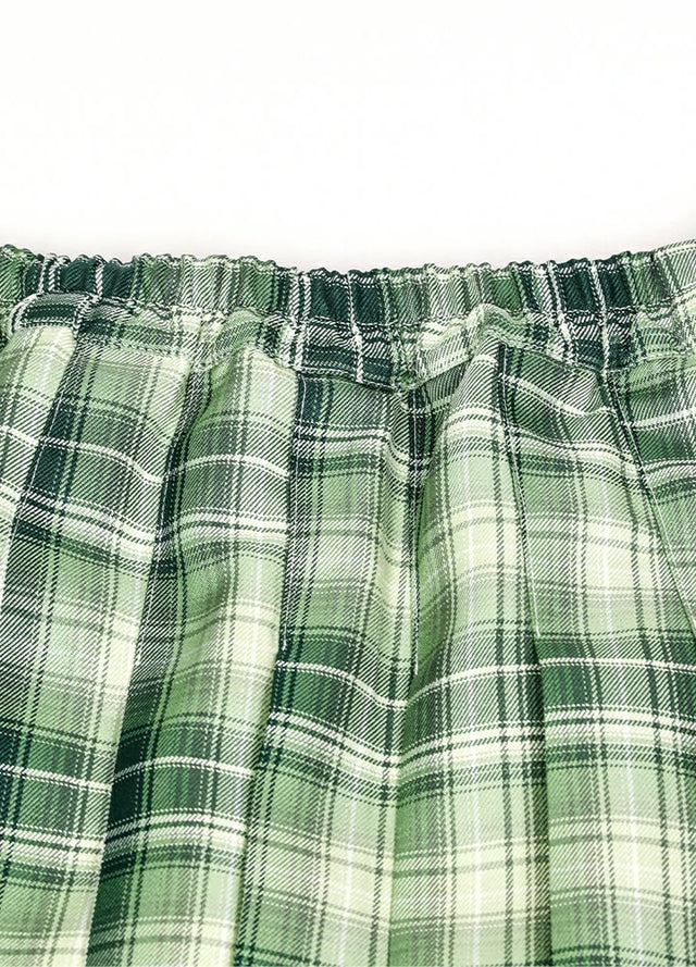 Detailed view of womens side button green plaid mini pleated skirt elastic waist