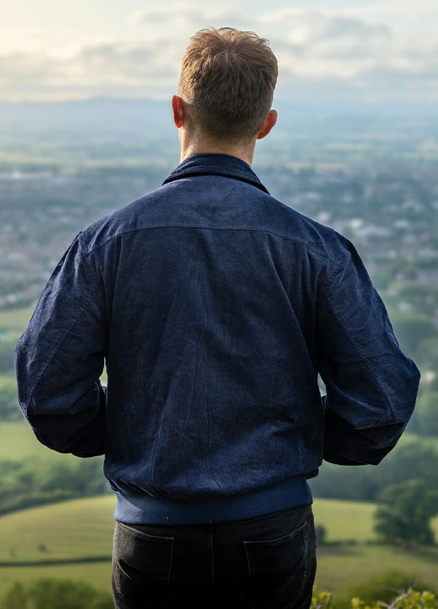 Back view of a man in a navy men's winter vintage corduroy solid jacket