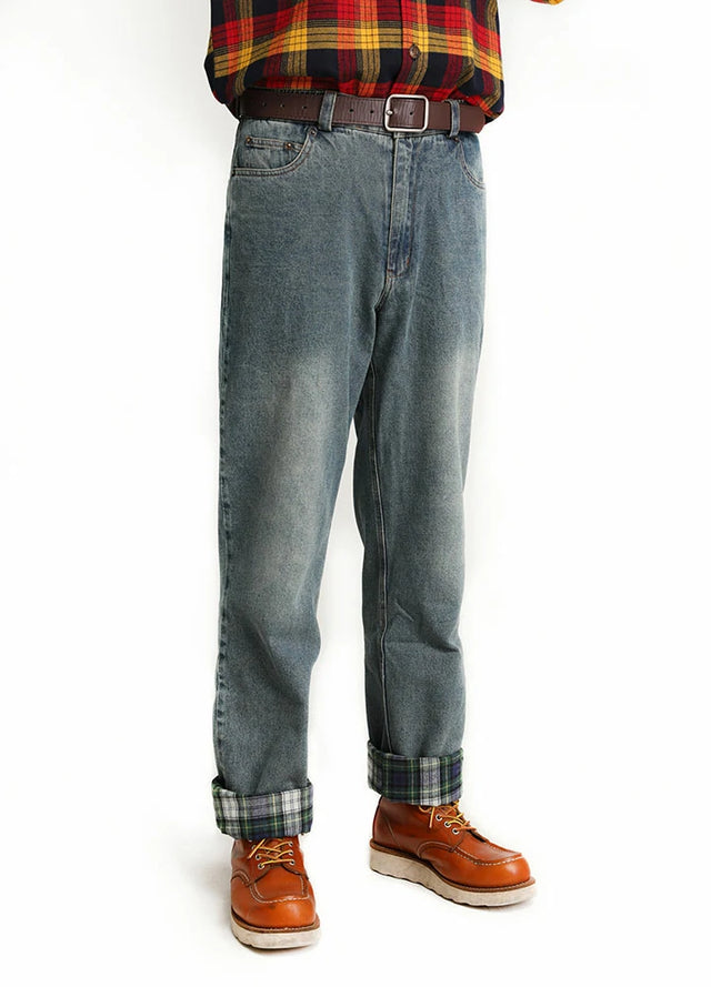 A man wearing flannel-lined straight-leg jeans, standing sideways