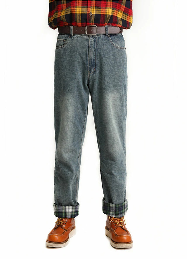 A man wearing flannel-lined straight-leg jeans, facing forward with his hands in his pockets