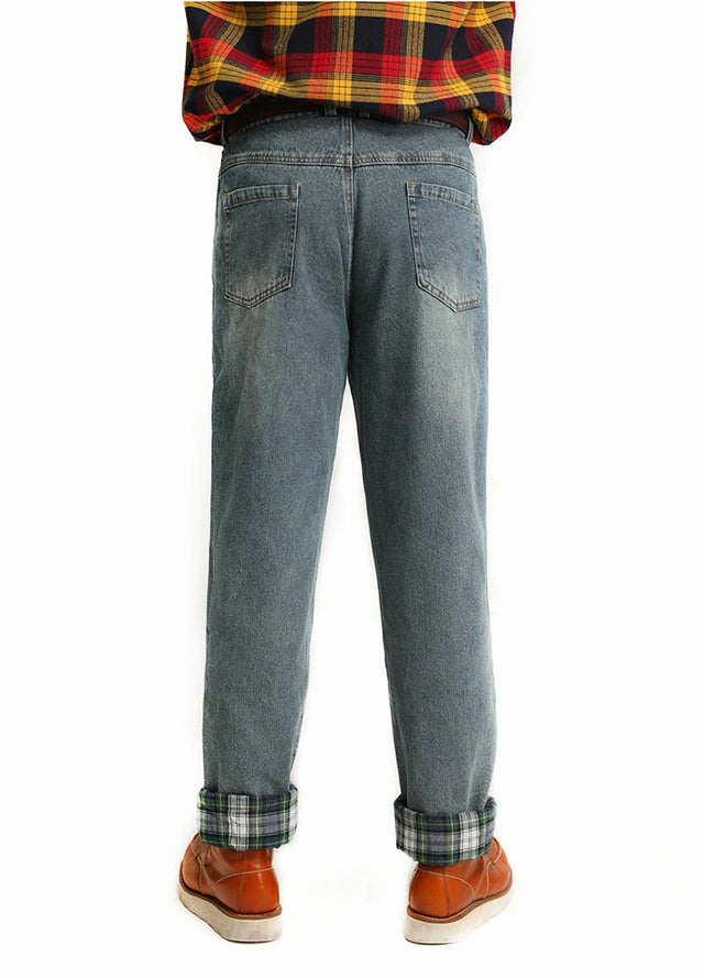 A man wearing flannel-lined straight-leg jeans, standing with his back turned