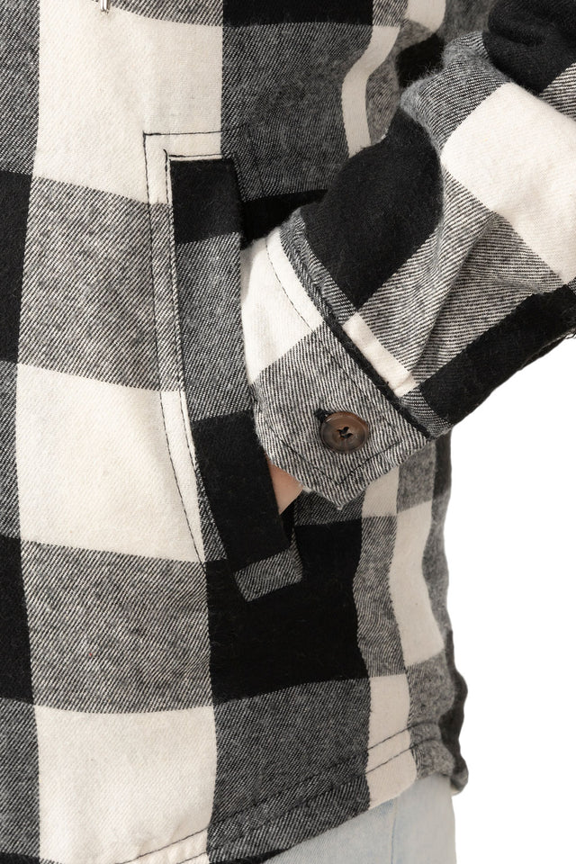 Close-up of womens black plaid winter warm plaid jacket hand pocket