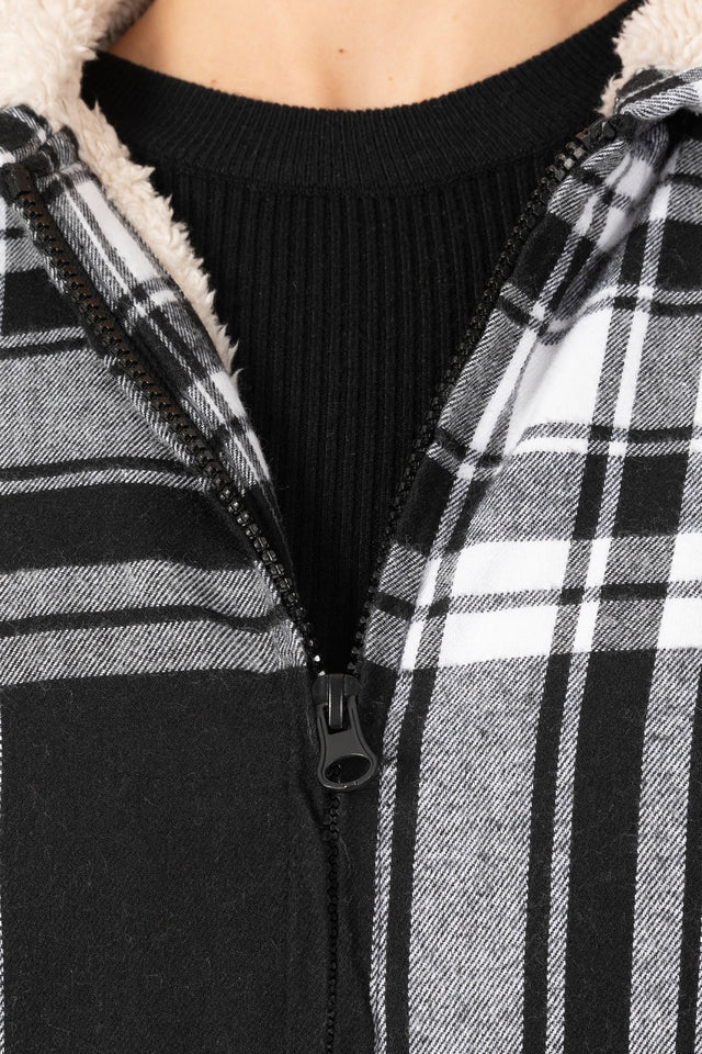 Detailed view of women's black white plaid sherpa lined flannel hooded zip