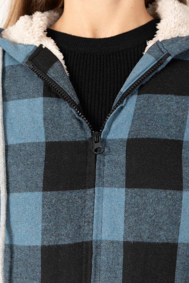 Detailed view of women's checkered blue black sherpa lined hooded jacket zip