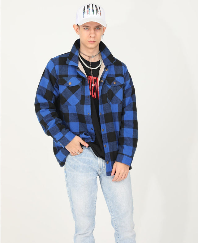 A boy in a hat wearing a blue flannel shacket