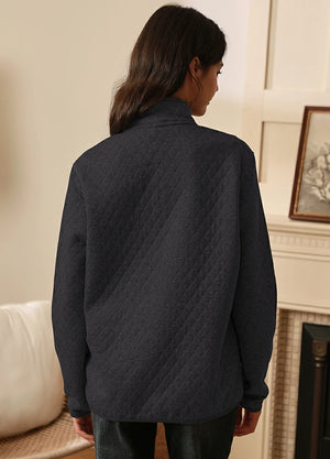 Back view of women in a solid black winter quilted fleece pullover