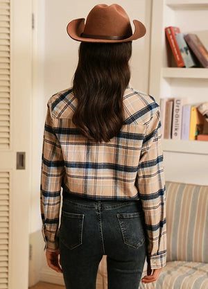 Back view of women in a khaki navy plaid soft flannel shirt