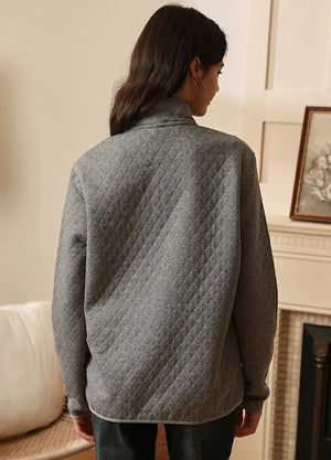 Back view of women in a light gray heather winter fleece pullover