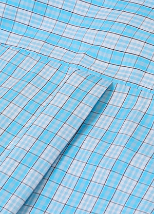 Close-up of women's pearl snap western baby blue plaid vest back design