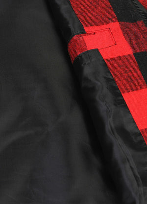 Close-up of women's black and red sleevesless quilted flannel plaid vest collar