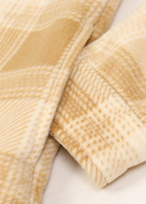 Detailed view of womens yellow button down plaid shacket hand pocket