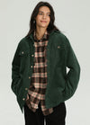 Women wearing a dark green corduroy shirt jacket