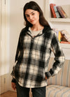 Women in a white black plaid sherpa-lined flannel hooded jacket