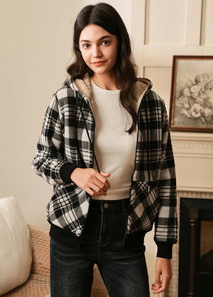 Women in a black sherpa lined zip up plaid hooded sweatshirt