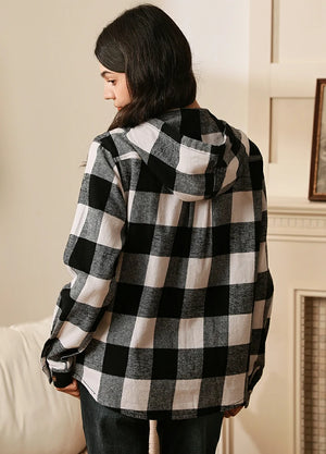 Women in a black white plaid flannel hoodie back view