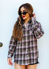 Women in a pink button down printed flannel plaid shirt