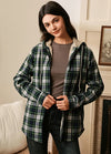 Women in a green plaid sherpa-lined flannel plaid jacket with hood