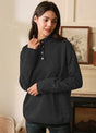 Women in a solid black 1/4 quilted fleece pullover with snap button