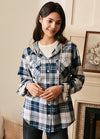Women in a white blue plaid button down flannel plaid hooded shirt