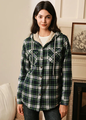 Women in a plaid green sherpa lined plaid jacket with hood