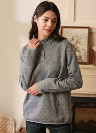 Women in a soft light gray heather 1/4 quilted fleece pullover