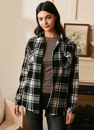 Women in a black white plaid button down flannel shirt jacket with sherpa lining