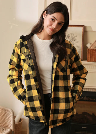 Women in a yellow quilted lined plaid shirt jacket with hood