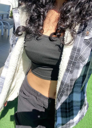 Women wearing a gray and white winter plaid hoodie with sherpa lined