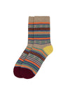 A pair of crew socks with a multicolor Fair Isle pattern on a beige base, featuring a yellow heel, dark burgundy toes, and orange and blue stripes.