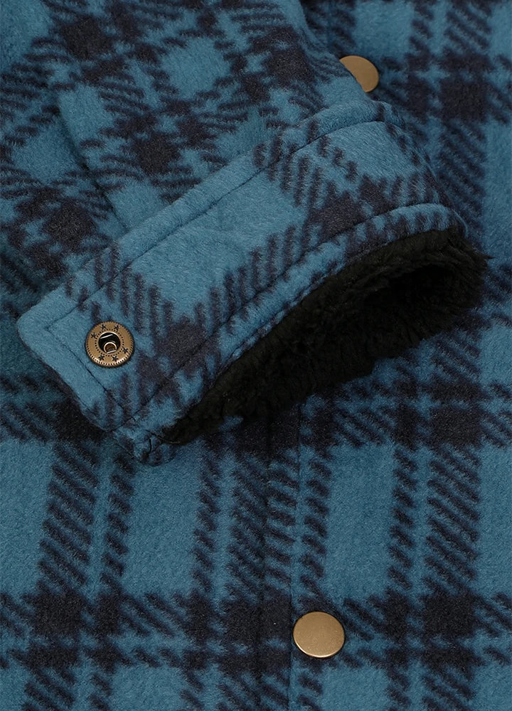 Close-up of a blue and black plaid fleece jacket with a dark sherpa lining and brass snap buttons.