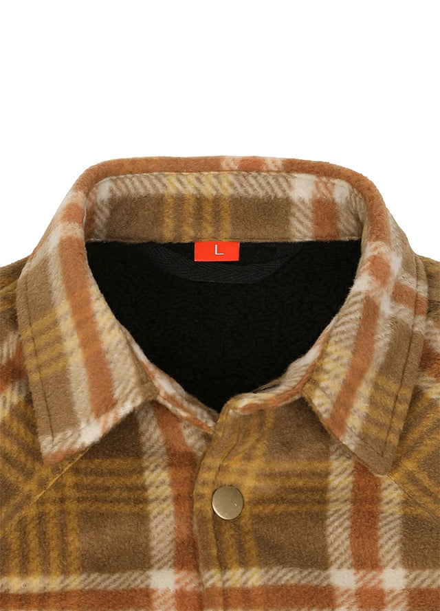 Close-up of a plaid fleece button-up shirt collar with a black fleece lining and a small red size label reading 'L'.