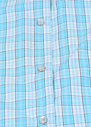 Zoomed-in view of the button on a women's baby blue sleeveless plaid vest
