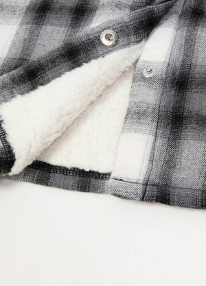 Zoomed-in view of the hem on a womens black white flannel hooded jacket