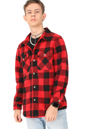 A boy who wears a red buffalo plaid shirt jacket
