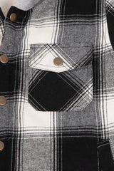 Close-up of the pocket of midnight black toddler warm sherpa lined snap button flannel hooded