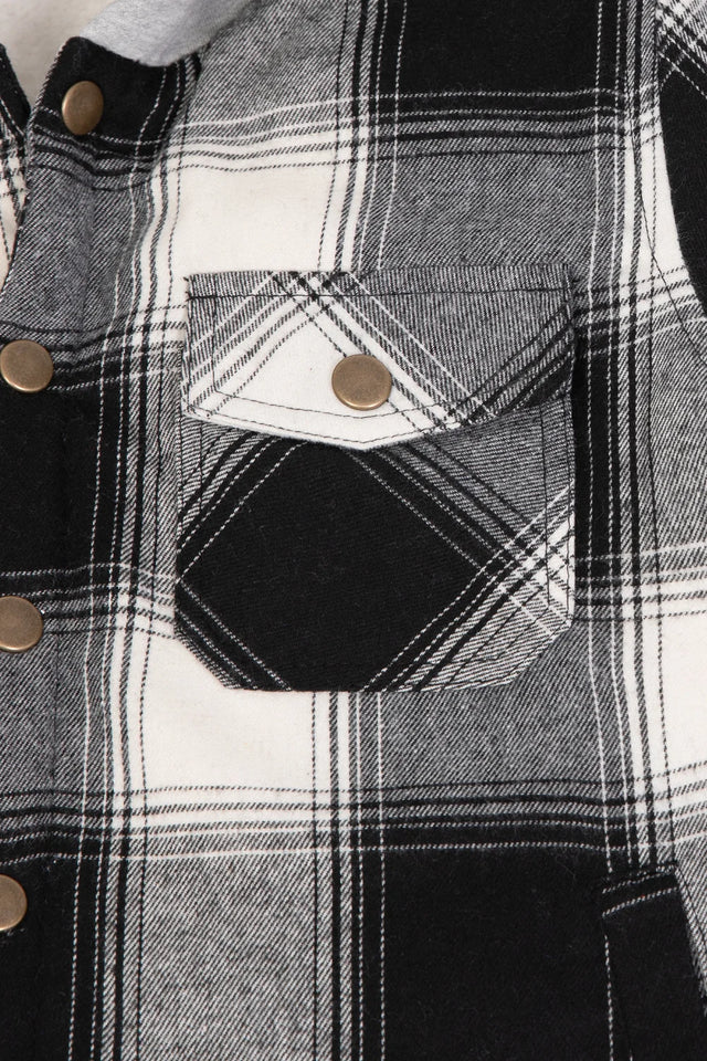 Close-up of the pocket of midnight black toddler warm sherpa lined snap button flannel hooded