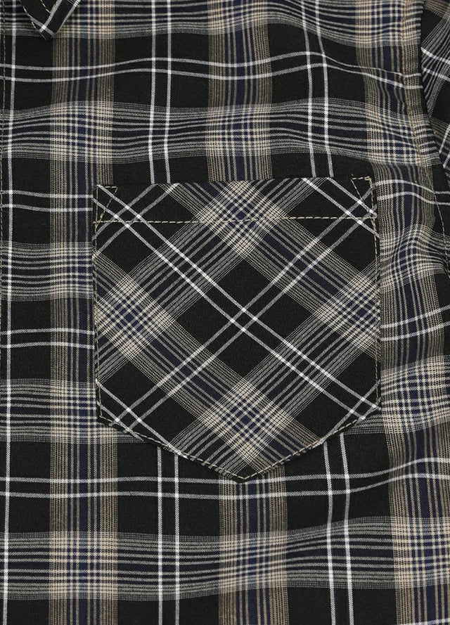 Detailed close-up of single chest pocket on kids plaid short sleeve shirt