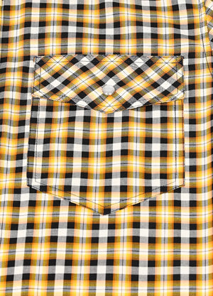 Close-up of pocket with button on kids yellow short-sleeve shirt