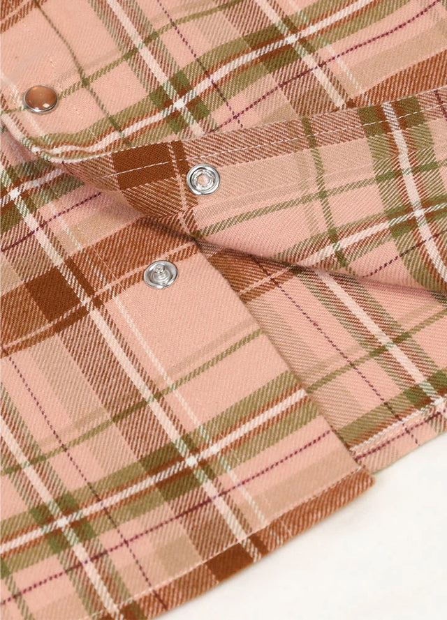 Detailed close-up of pearl snap on kids rose latte short-sleeve shirt