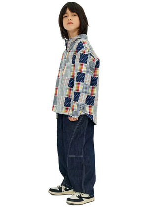 Side view of boy wearing a long sleeve pathwork flannel shirt