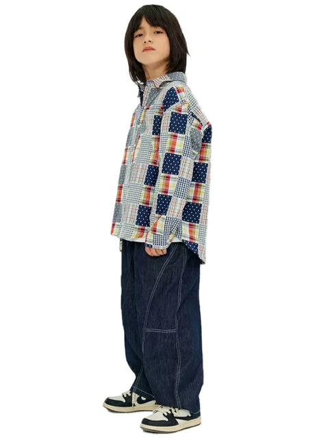 Side view of boy wearing a long sleeve pathwork flannel shirt