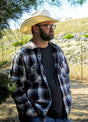 A man chopping wood in a coffee white men's stalwart heavyweight cotton plaid shirt